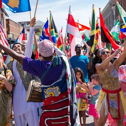 Members of the Ohio University community wave international flags in the global parade