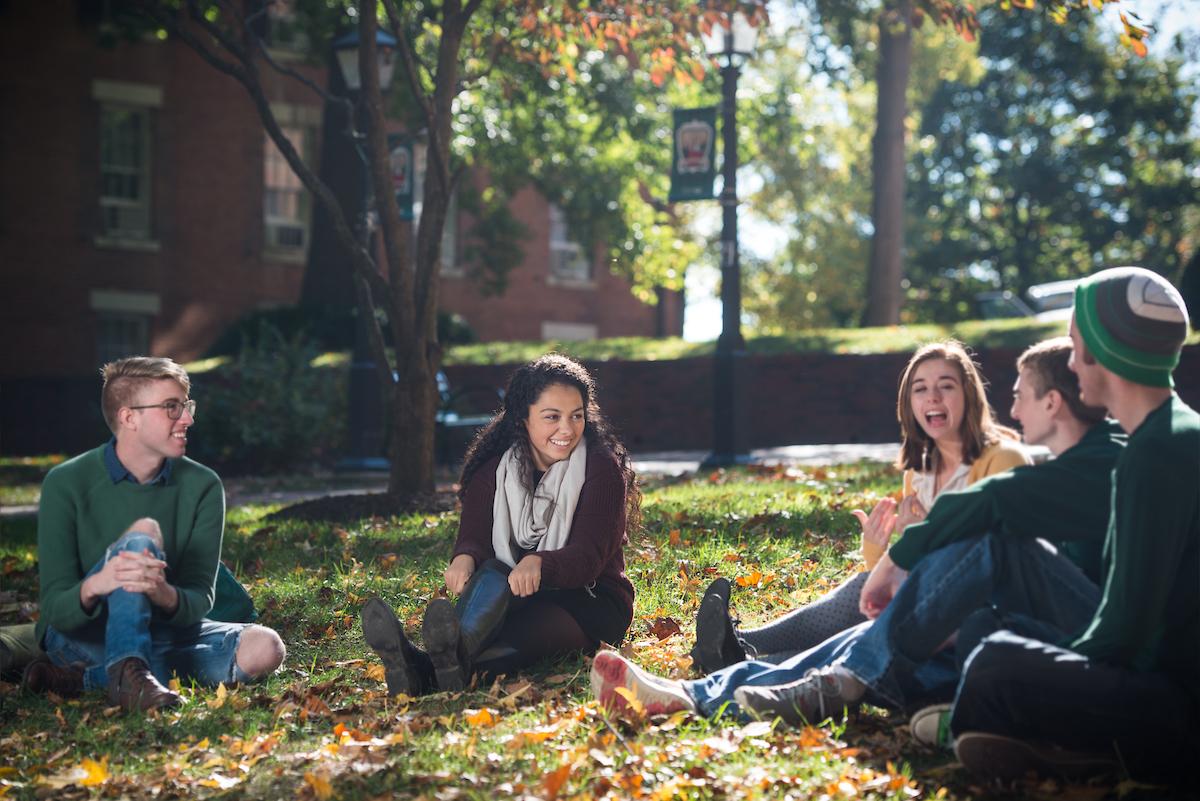 Students sit and talk in College Green